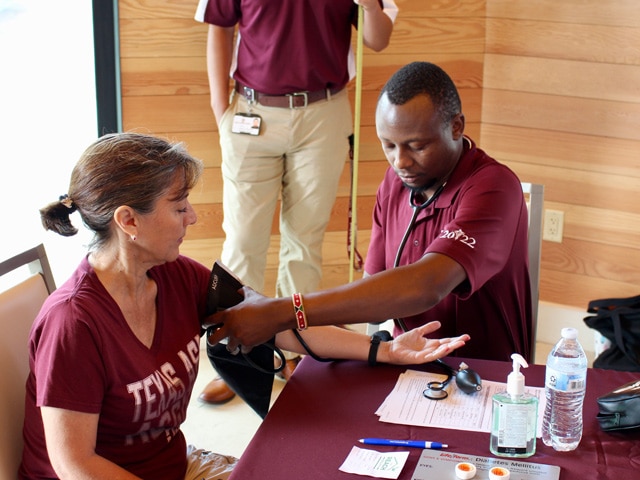 REACH Health Programs - medic giving blood pressure reading